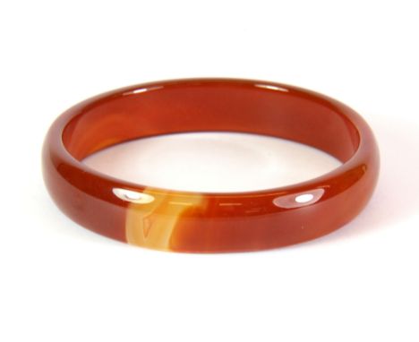 A polished cornelian bangle, Dia. 7cm.