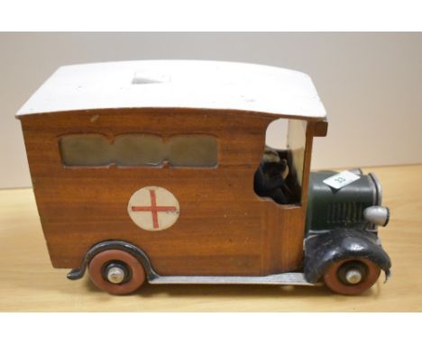 A vintage wooden ambulance ornament, measuring 29cm long