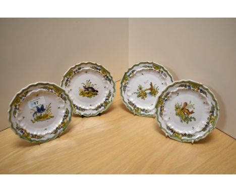 Four French Quimper ware style saucers, hand decorated with scenes from nature, diameter 14cm