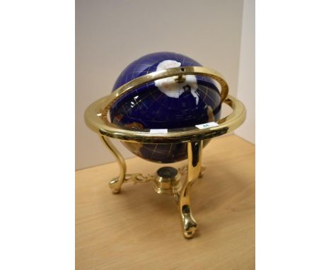 An enamelled terrestrial globe displayed within a brass gimballed frame, measuring 36cm tall