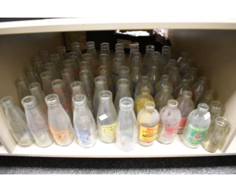 Approximately fifty vintage glass dairy advertising milk bottles, for various including J.Leigh, Spring Farm, Guide, Nr Black