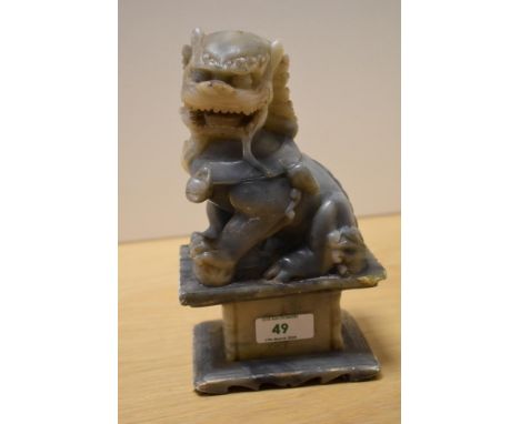 A Chinese soapstone carved Foo Dog statue, measuring 20cm tall