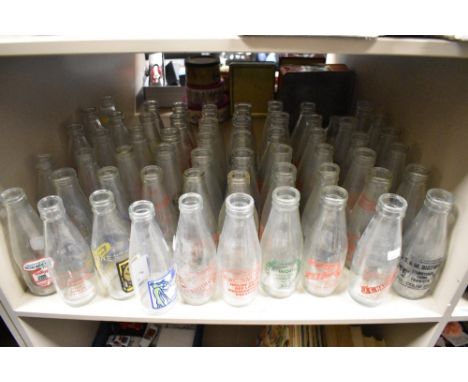 A collection of approximately fifty vintage dairy advertising milk bottles, various to include R.Wood, Lane end Farm, Lowick,