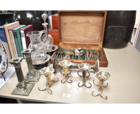 A pair of silver-plated Corinthian column candlesticks with rams head and swag ornaments to the flared/swept base, sold along