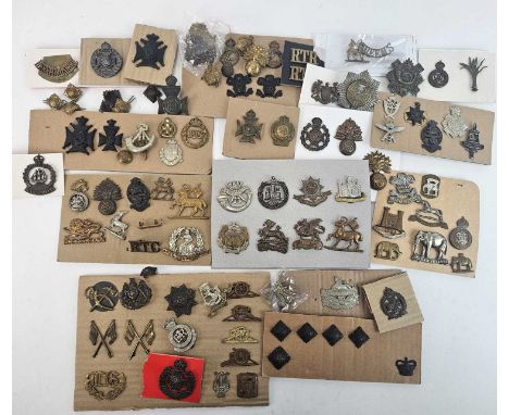 A large accumulation of British and foreign Army cap badges and buttons together with a large assortment of cloth badges and 