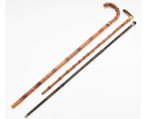 Three swordsticks, the first with a black painted shaft (worn), white metal collar and a 13th Hussars badge, blade length 68.