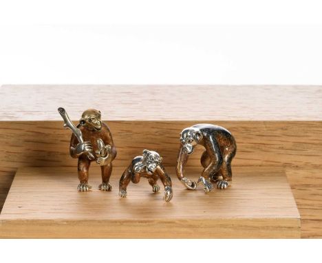 THREE SILVER AND ENAMEL MINIATURE FIGURES,. SATURNO all three modelled as chimpanzees, one with club, another eating a banann