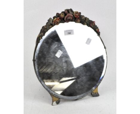 An antique circular bevelled edge table mirror, mounted onto a wooden frame carved and painted with floral details, height 34