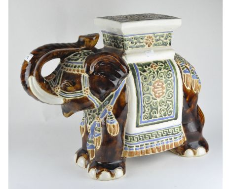 A vintage ceramic jardinière stand in the form of an elephant, in brown and green glaze with blue decoration, height 42cm