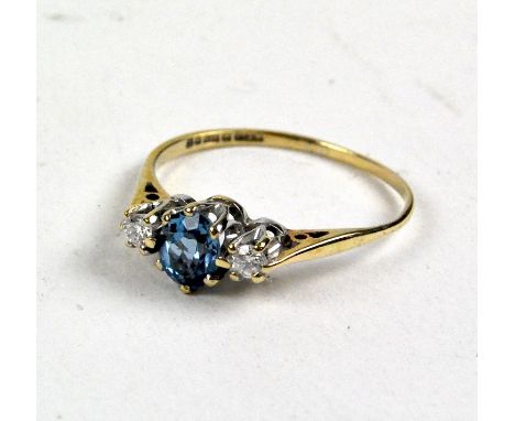 A ladies 9ct gold ring, with centrally set Topaz flanked by two smaller diamonds, UK ring size L