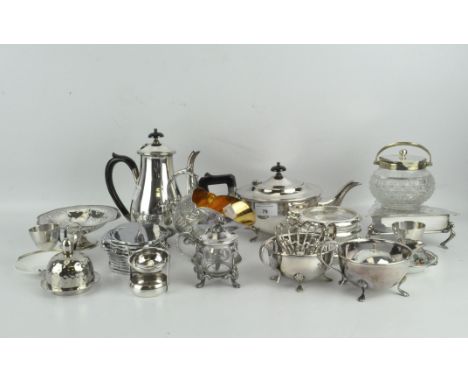 A group of silver plated wares, including an ornate sugar scuttle, three piece tea set, trinket box and more