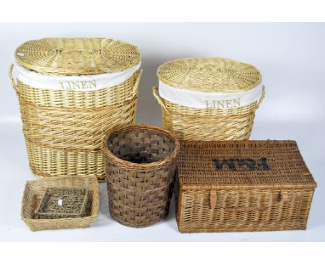 A large quantity of contemporary wicker baskets, including two with lids and handles, together with two trays and a picnic ha
