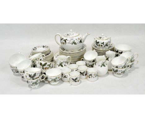 A Wedgwood part tea service in the 'Strawberry Hill' pattern, including cups and saucers, milk jugs, plates and a teapot.