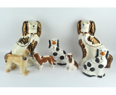 A collection of contemporary ceramic dogs including two pairs of King Charles spaniels, and three further dogs, largest 31.5c
