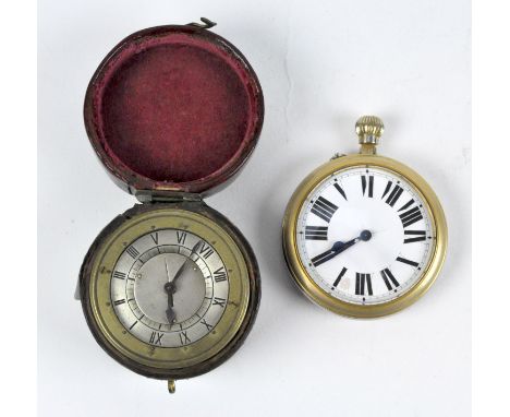 A 19th century travelling alarm clock of cylindrical form, the brass case with engraved ribbed decoration, the silvered dial 