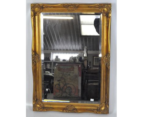 A modern gilt framed wall mirror, with bevelled edge, 89cm x 63cm.