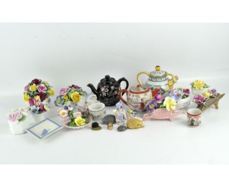 Eleven ceramic flower posies, together with three teapots, a Wedgwood dish, pin cushion head, thimble and miniature hedgehogs
