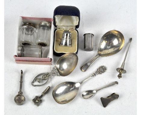 A selection of silver and white metal pieces, to include a Georgian silver caddy spoon, two menu holders, thimble and more