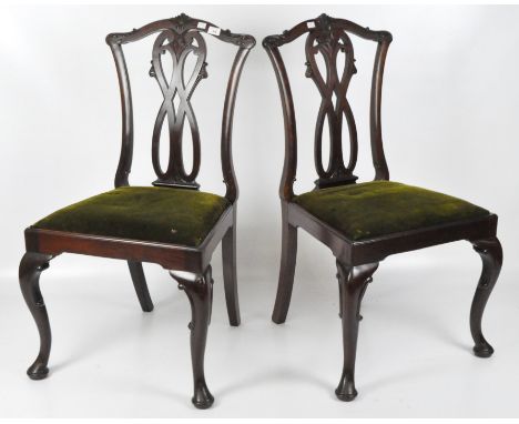 A pair of mahogany Chippendale-style chairs with pierced scrolling splat, green velvet seats, raised on cabriole legs, height