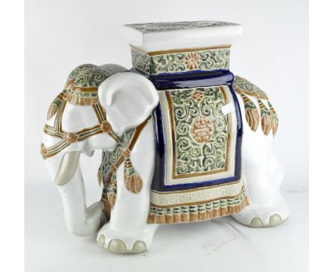 A vintage ceramic jardinière stand in the form of an elephant, in white glaze with blue, brown and green decoration, height 4
