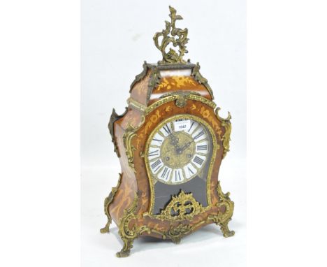 An elaborate reproduction clock in the Georgian style, the veneered exterior decorated with flowers and gilt cast metal scrol