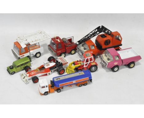 A collection of vintage tiplate and diecast toys, including a fire engine, crane and racing car