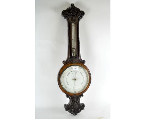 A Murray &amp; Heath wall barometer, mounted in a carved mahogany frame with a thermometer attached, height 82cm