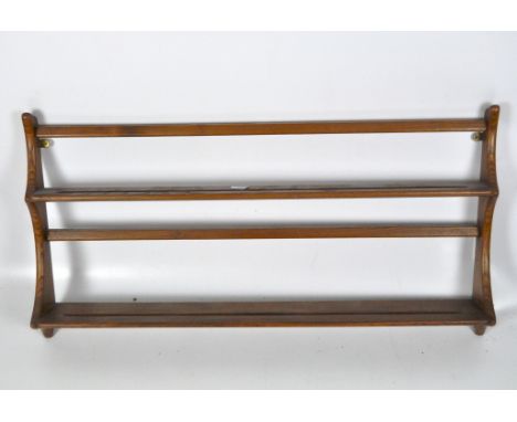 An Ercol golden elm wall shelf, 45cm x 96cm x 13cm