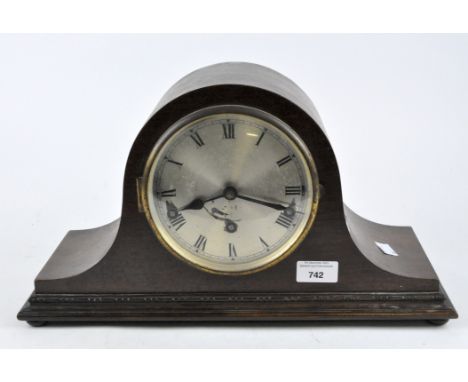 An antique Napoleon hat mantle clock, silvered dial with Roman numerals, in a mahogany case raised on bun feet, height 23cm.