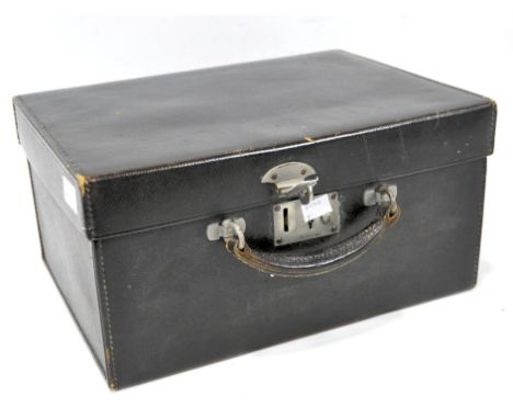 A leather vanity case by Finnigans, with a fitted green silk interior, still containing the original notebook and comb, carry