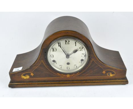 A Napoleon hat mantle clock, the silvered dial with Arabic numerals, the mahogany case with inlaid details and supported on b