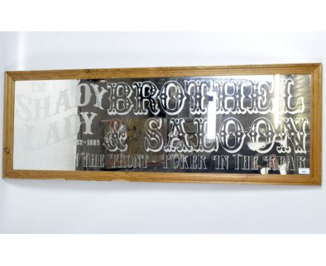 A framed mirror embellished with wording reading 'The Shady Lady Brothel and Saloon...', 46cm x 130cm