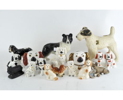 A collection of ceramic dog figurines of various breeds, including Beswick, and more, maximum height 23cm