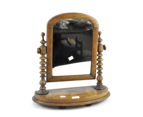 A Victorian mahogany swing top toiletry mirror, with turned supports and a curved plinth base, height 49cm.