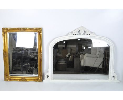 A Victorian bevelled edge over mantle mirror, with carved scrolling decoration, later painted white, 90cm x 125cm