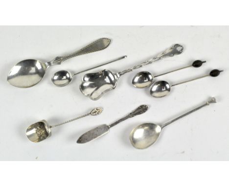 A selection of silver flatware, including a child's spoon, another two with shell enamelled detailing to the underside of the