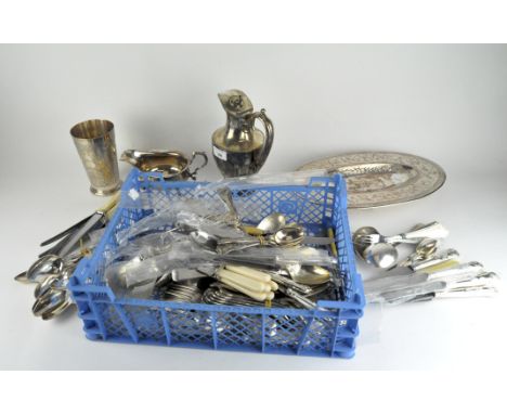 A selection of silver plate, including flatware, a beaker, gravy boat and more