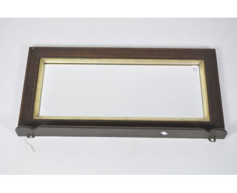 A Victorian rectangular wall mirror, within a mahogany frame with ribbed details, 38cm x 75cm.