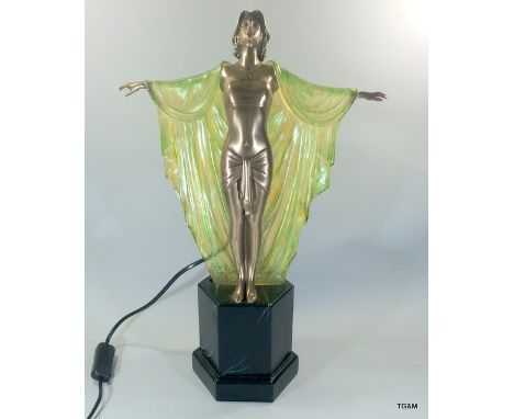 An Art Deco style lamp in the form of a young lady with a cloak