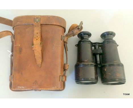 A pair of WW1 binoculars marked 22499 with the War Department arrow in their original brown leather case marked Oak Leather G