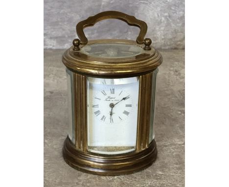 A L'Epee brass oval carriage clock, 11 jewel movement, white dial, black Roman numerals, swing handle 