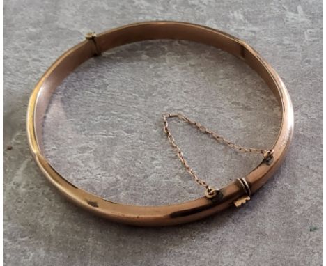 A 9ct rose gold hollow hinged bangle, stamped 9ct 6.46g 