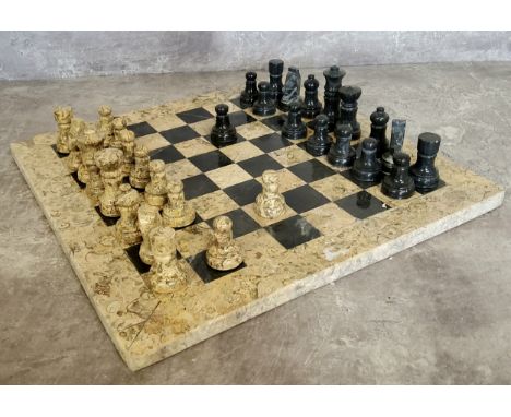 A highly polished fossilised coral and black marble chess set 