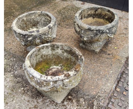 A set of three squat cast concrete planter / urn,&nbsp; depicting bows and fruits 34cm h x 37.5 cm dia 