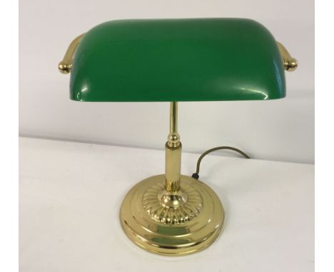 A reproduction brass desk lamp with green glass shade.