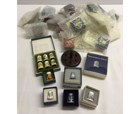 29 Collectors Thimble Club ceramic thimbles including Spode, Limoges, etc. plus a set of 6 with wooden stand. All in original