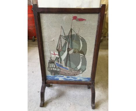A glazed dark oak tapestry firescreen depicting a galleon.
