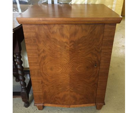 A 1930's Walnut sewing machine cabinet with modern Singer electric sewing machine. With note from vendor re history of item.