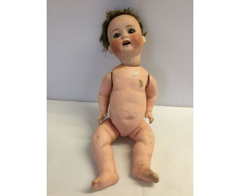 Vintage Heuback Koppelsdorf bisque head doll with composition body. Eyelids damaged, some wear to body. Approx 21" tall.