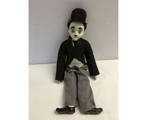 A Charlie Chaplin doll with bisque head, hands & feet on a soft body.